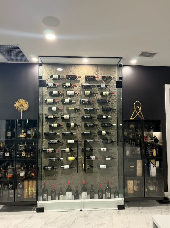 Glass-enclosed wine room with climate-controlled display